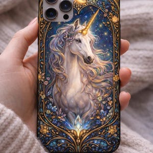 May include: A phone case featuring a majestic white unicorn with a golden horn and flowing mane. The design includes a starry night sky background, floral accents, and a decorative gold border. The case is held by a hand.