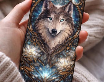 May include: A phone case featuring a detailed illustration of a wolf with blue eyes. The design includes floral and celestial elements in gold and blue tones, creating an artistic and mystical aesthetic.