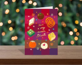 May include: A greeting card with a dark purple and maroon plaid background featuring illustrations of various Indian sweets arranged in a circle around the gold text that reads Have a very sweet Diwali, accented with small colorful star and flower icons.