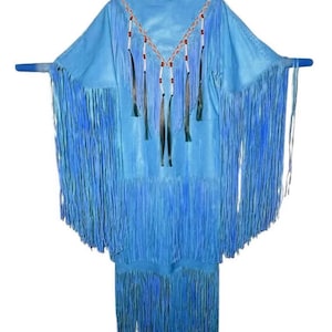 May include: A light blue leather dress with long fringe detailing. The dress features a V-neckline adorned with beaded accents in red, white, and brown. The sleeves are wide, and the dress is displayed on a hanger.