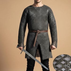 May include: A chainmail shirt with long sleeves and a brown leather belt. The shirt is made of small, interlocking metal rings. A silver sword is held in the hand. The outfit is worn with black pants.
