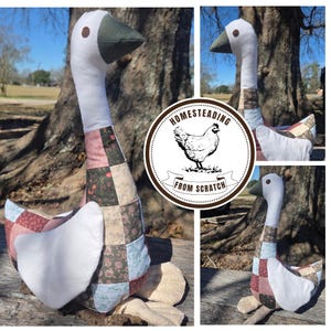 May include: A handmade goose-shaped decorative pillow. The goose has a white head and neck, a green beak, and a patchwork body in shades of pink, blue, and brown. The pillow is designed to look like a goose and is made of fabric.