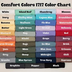 May include: A color chart titled "Comfort Colors 1717 Color Chart" displays a variety of fabric colors. The chart includes shades like white, pink, blue, green, yellow, orange, and grey. Each color is labeled with its name.