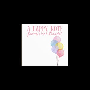 May include: A white square card with the text "A HAPPY NOTE from First Grade!" in pink script. Watercolor balloons in pink, blue, yellow, and purple are tied together with black strings.