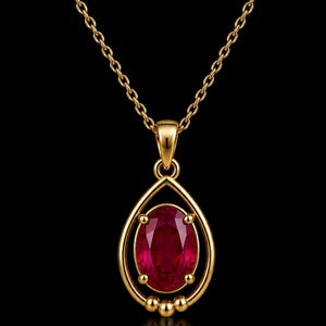 May include: A gold necklace featuring an oval-cut deep red gemstone pendant set within a teardrop-shaped gold frame. The pendant is suspended from a delicate gold chain, with three small gold spheres accenting the base of the teardrop setting.