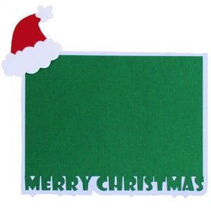 May include: A green card with a white border and the words "Merry Christmas" cut out in white. A red and white Santa hat is in the top left corner.