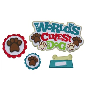 May include: World's Cutest Dog paper craft with paw prints, a dog bowl, and a bone. The words are in red, green, blue, and yellow.