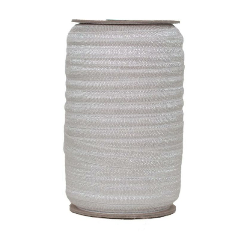 May include: A roll of white elastic trim with a slight sheen. The trim is wound around a cardboard core.