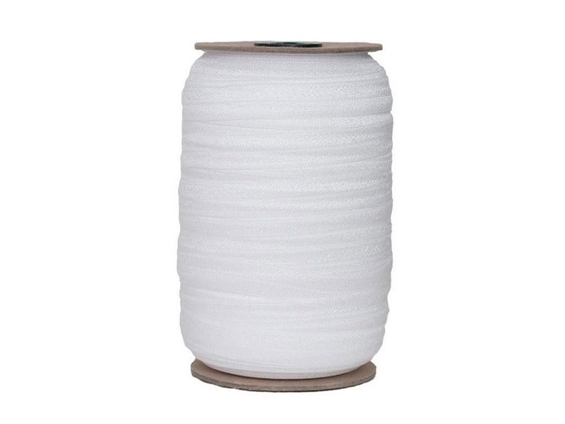 May include: A spool of white elastic trim, wound on a cardboard spool.