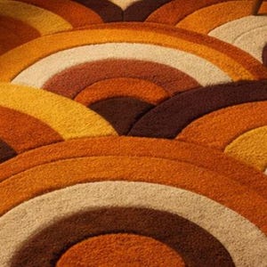 Handmade retro rainbow arch tufted area rug featuring geometric mid century modern design in burnt orange, mustard yellow, cream, and brown tones for boho living room decor.