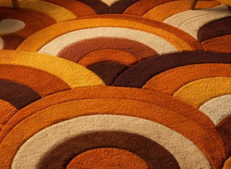 Handmade retro rainbow arch tufted area rug featuring geometric mid century modern design in burnt orange, mustard yellow, cream, and brown tones for boho living room decor.