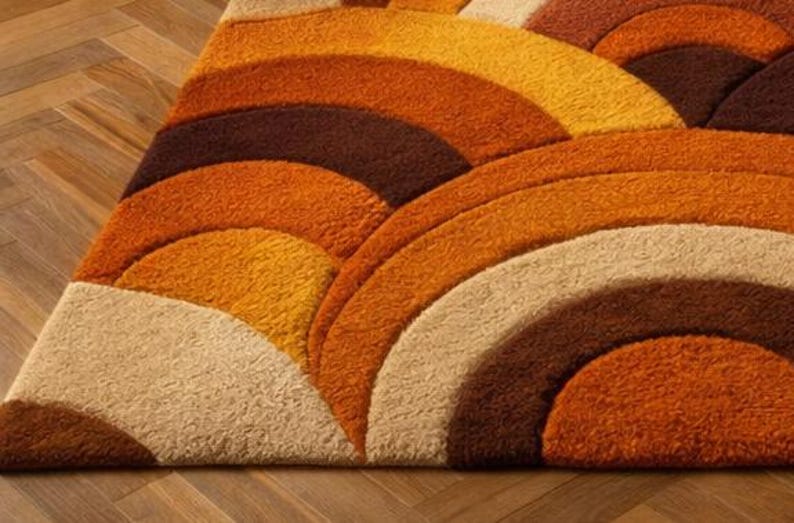Handmade retro rainbow arch tufted area rug featuring geometric mid century modern design in burnt orange, mustard yellow, cream, and brown tones for boho living room decor.