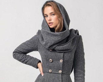 May include: A gray wool coat with a large hood and a double-breasted closure. The coat has a flared skirt and is lined with a soft fabric.