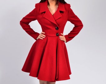 May include: A woman wearing a red coat with a flared skirt and black heels. The coat has a button closure and a collar.