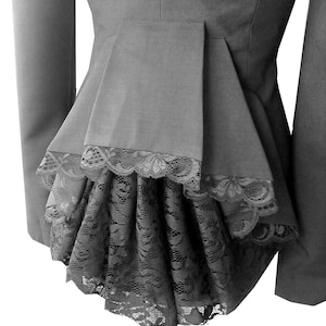 May include: A black blazer with a fitted waist and a lace trim at the bottom. The blazer has a peplum style back.