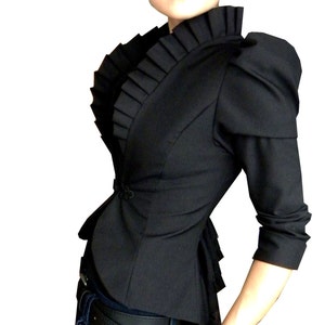 May include: A black fitted blazer with a ruffled collar and puffed sleeves. The blazer has a fitted waist and a slightly longer back hem.