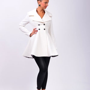 Full front view of the coat showing wide lapels, long sleeves, and double-breasted buttons