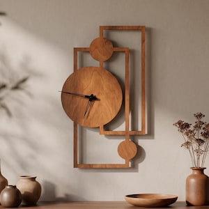 May include: A walnut wall clock featuring a large circular face with black hands, integrated into a geometric frame composed of rectangular and circular wooden elements. The word WALNUT is printed in the top right corner of the image.