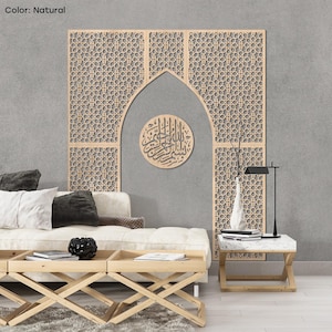 May include: A natural-colored, laser-cut wooden wall panel with an Islamic geometric pattern. The panel features an arched design and a circular wooden plaque with Arabic calligraphy. The panel is part of a living room decor.