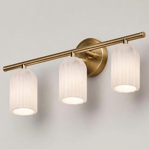 May include: A three-light vanity fixture with a brass finish. The fixture features three frosted glass shades with a ribbed design. The shades are cylindrical with a scalloped bottom edge. The fixture is mounted on a round brass backplate.