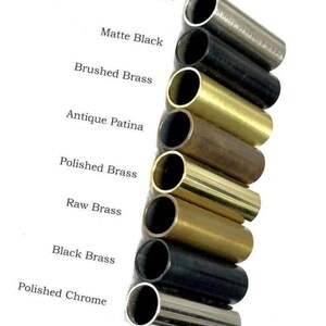 May include: A vertical arrangement of eight cylindrical metal tubes in various finishes, labeled as Brushed Chrome, Matte Black, Brushed Brass, Antique Patina, Polished Brass, Raw Brass, Black Brass, and Polished Chrome, displayed on a white background.