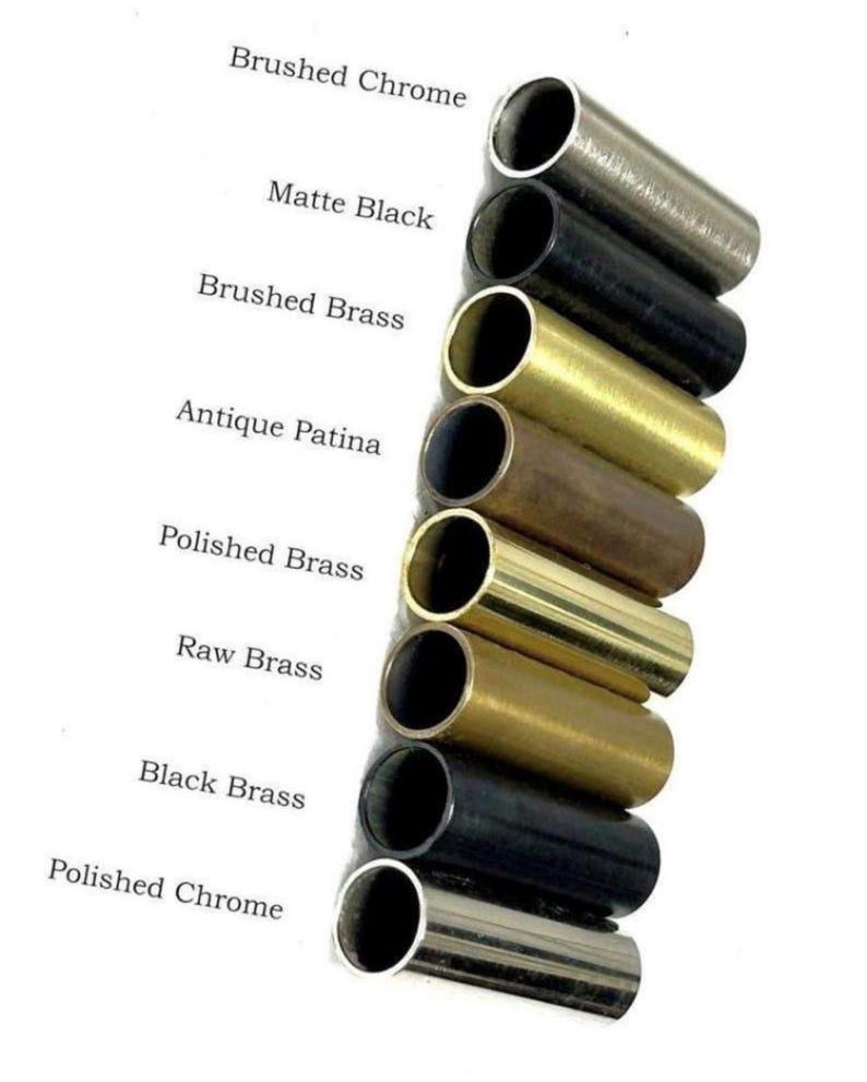 May include: A vertical arrangement of eight cylindrical metal tubes in various finishes, labeled as Brushed Chrome, Matte Black, Brushed Brass, Antique Patina, Polished Brass, Raw Brass, Black Brass, and Polished Chrome, displayed on a white background.