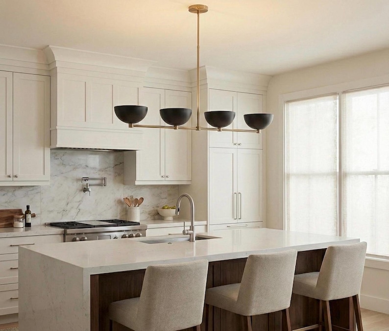 May include: A linear chandelier featuring a thin, horizontal brass rod suspended from the ceiling by a single vertical stem. The fixture holds four matte black, bowl-shaped shades arranged in a row, providing downward-facing illumination.
