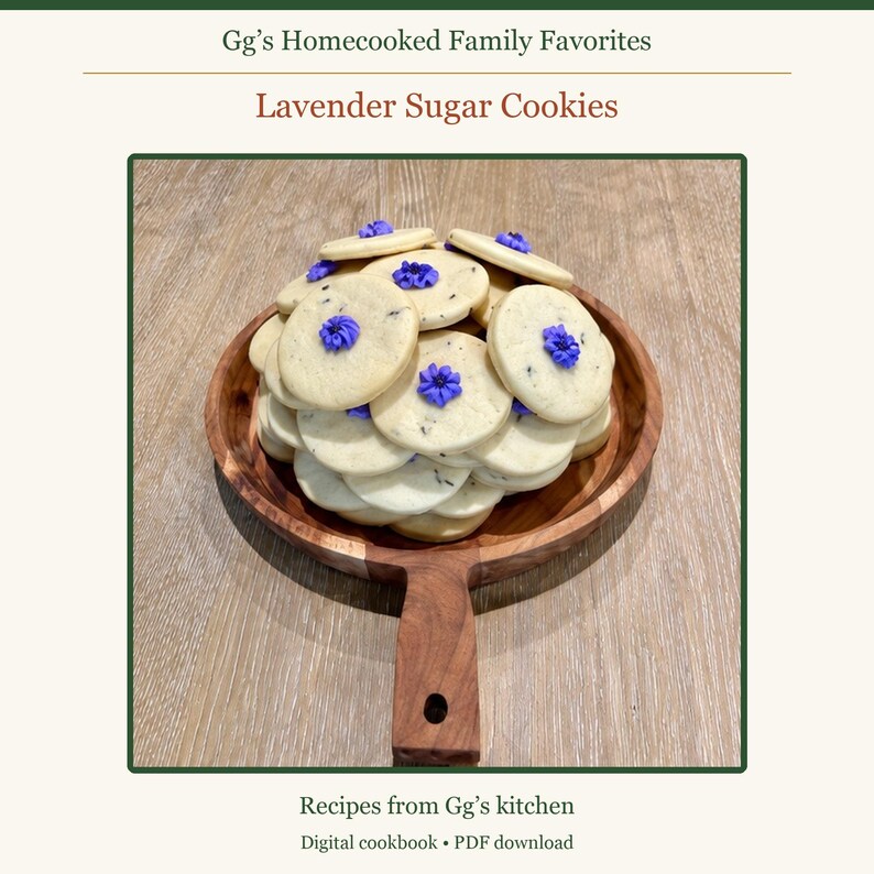 May include: A stack of round, light-colored sugar cookies with small purple flower-shaped icing decorations, served on a round wooden serving board with a handle. The text reads Gg's Homecooked Family Favorites, Lavender Sugar Cookies, Recipes from Gg's kitchen, Digital cookbook &bull; PDF download.
