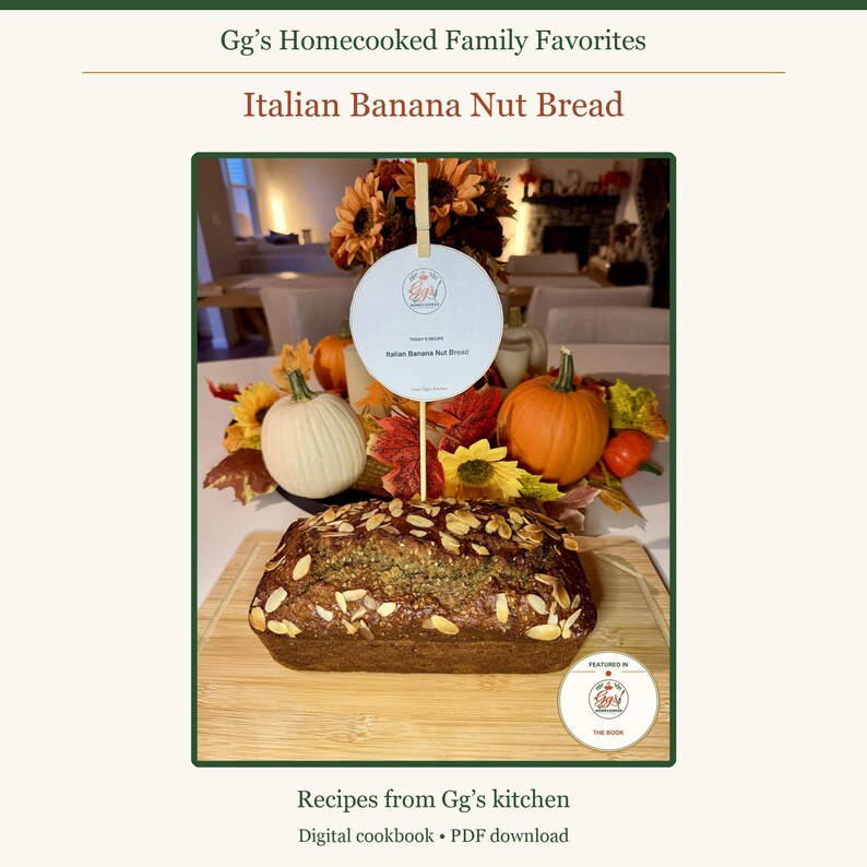 May include: A loaf of banana nut bread topped with sliced almonds on a wooden cutting board. A circular sign on a stick reads Gg's Homecooked Family Favorites and Italian Banana Nut Bread, surrounded by decorative pumpkins and autumn leaves.