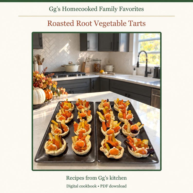 May include: A digital cookbook titled Gg's Homecooked Family Favorites featuring Roasted Root Vegetable Tarts. The cover displays two rectangular black platters holding small pastry tarts topped with roasted carrots and squash.