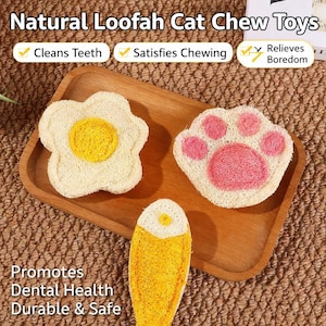 May include: Natural loofah cat chew toys in the shape of a flower, paw print, and a long oval. The flower has a yellow centre, the paw print has pink pads, and the oval has a yellow top. Text reads: Cleans Teeth, Satisfies Chewing, Relieves Boredom, Promotes Dental Health, Durable & Safe.