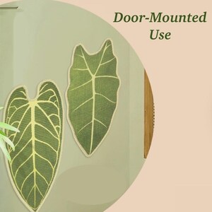 May include: Two green leaf-shaped decorative items with light green veins and a beige border are mounted on a light green surface. The text "Door-Mounted Use" is displayed in dark green. The items are likely for home decor.