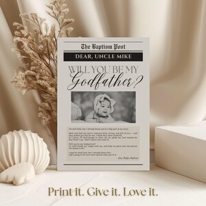 May include: A black and white newspaper-style card with the headline "The Baptism Post" and the text "Will You Be My Godfather?" A photo of a baby is in the center. The bottom reads "Print it. Give it. Love it."