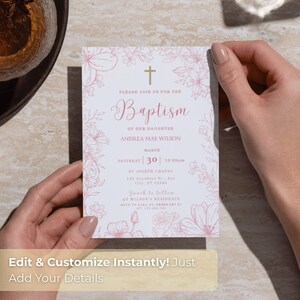 May include: A baptism invitation card held by hands. The card features a floral design in pink, with the word "Baptism" in elegant script. The text includes the name "Andrea Mae Wilson" and event details.