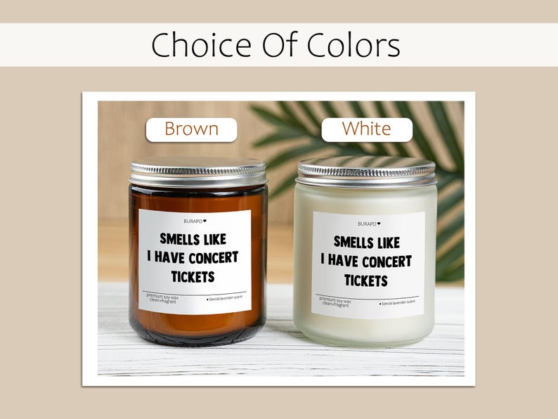 May include: Two scented candles in glass jars with silver lids. One is brown, the other white. Each has a label that reads "SMELLS LIKE I HAVE CONCERT TICKETS". The text "Choice Of Colors" is at the top.