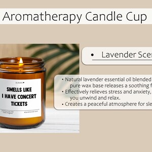 May include: Aromatherapy candle in a brown glass jar with a lit wick. The label reads "Smells Like I Have Concert Tickets." The candle has a lavender scent and is made with natural lavender essential oil.