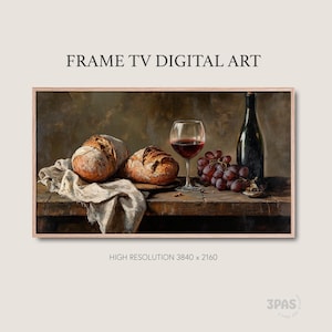 May include: Digital art print of a still life featuring two loaves of bread, a glass of red wine, a bottle of wine, and a bunch of grapes. The scene is set on a wooden table with a linen cloth. The artwork is framed and labeled "FRAME TV DIGITAL ART."