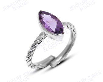May include: A sterling silver ring featuring a marquise-cut amethyst gemstone. The ring has a twisted band design and a polished finish. The gemstone is a vibrant purple color and is set in a bezel setting. The ring is a piece of jewelry.