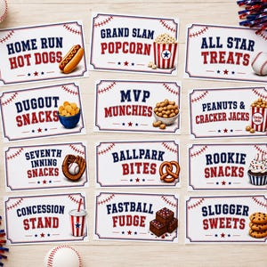 May include: A collection of baseball-themed food signs with red, white, and blue accents. Each sign features a different snack, such as hot dogs, popcorn, peanuts, and sweets. The signs are arranged on a light wood surface with baseballs and decorative elements.