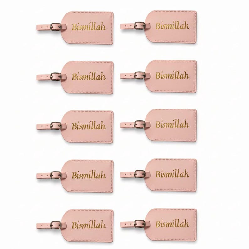 May include: A collection of ten pink luggage tags. Each tag has a rectangular shape with rounded corners and a small strap with a buckle. The word "Bismillah" is printed in gold lettering on each tag.