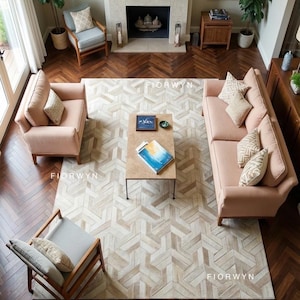 May include: An overhead view of a living room with a light pink sofa and armchair set, a patterned rug, and a wooden coffee table. The room has a fireplace, wooden floors, and two chairs.