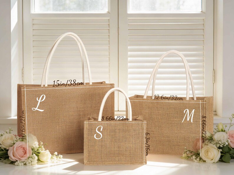 May include: Three burlap tote bags of varying sizes, each with white handles and a white initial. The largest bag is 15 inches wide and 10.6 inches tall. The medium bag is 12.6 inches wide and 8.66 inches tall. The smallest bag is 8.66 inches wide and 6.3 inches tall.