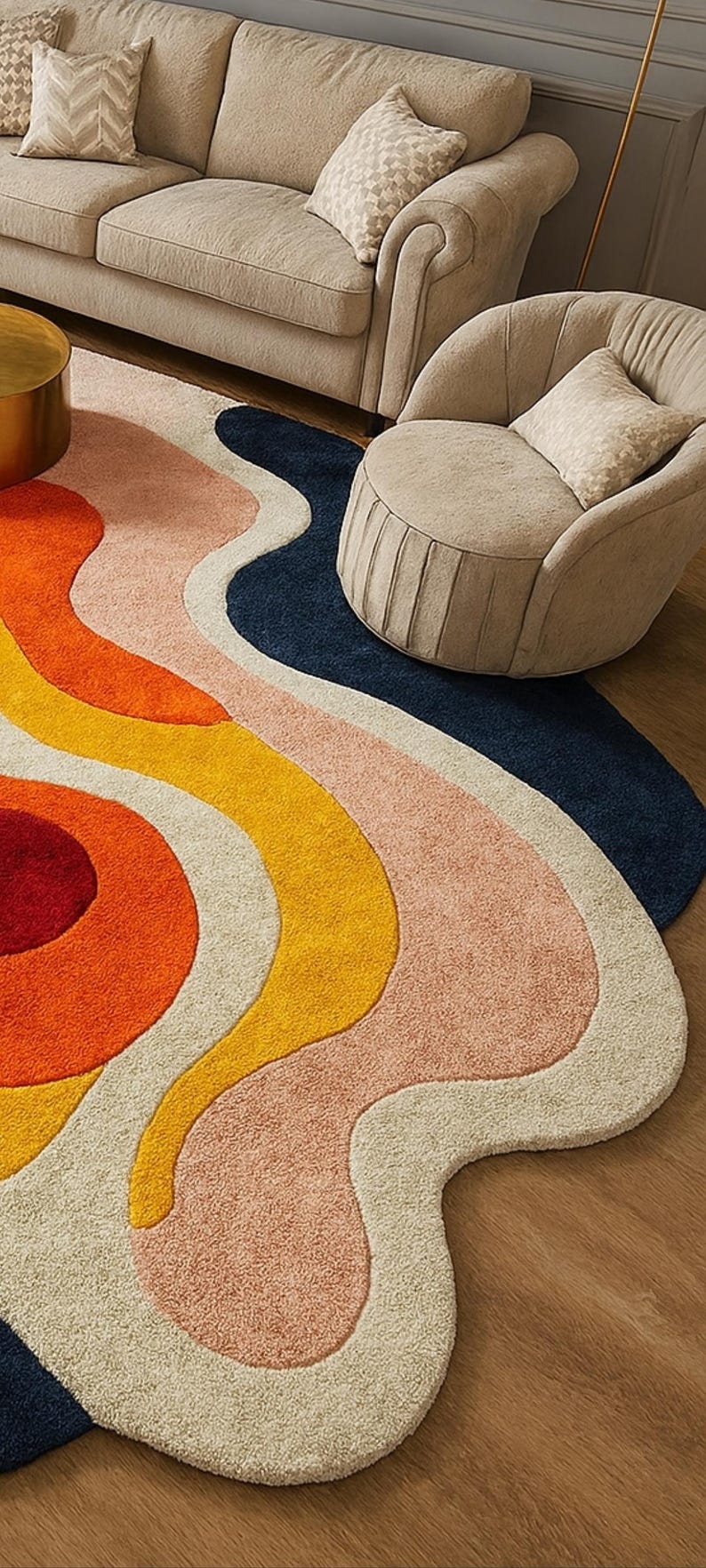 May include: A colorful, abstract area rug with a wavy design. The rug features a combination of colors, including orange, yellow, pink, cream, and navy blue. The rug is placed on a wooden floor, with beige furniture in the background.