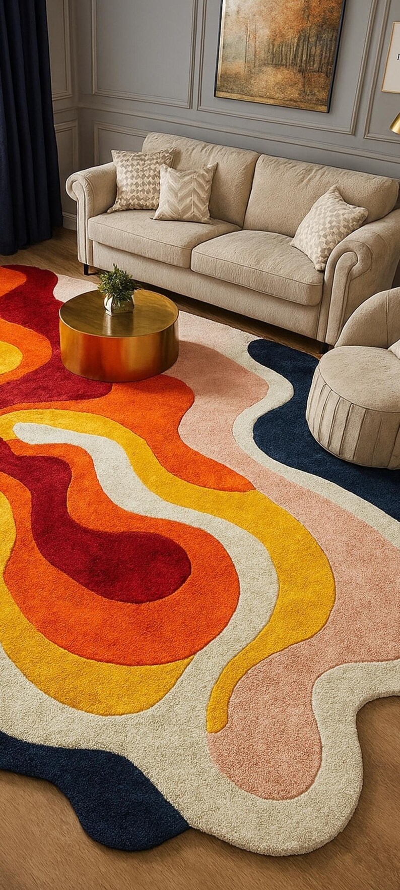 May include: A colorful area rug with an abstract design. The rug features flowing shapes in shades of red, orange, yellow, white, pink, and navy blue. The rug is placed on a wooden floor, with a sofa and chair in the background.