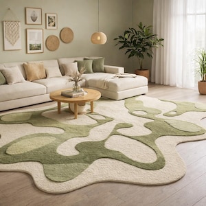 May include: A living room scene featuring a cream-colored sectional sofa with accent pillows, a round wooden coffee table, and a unique rug with green abstract shapes. The room is decorated with plants and wall art.