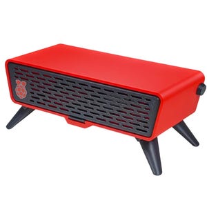 May include: A rectangular red electronic enclosure featuring a black front grille with a small Raspberry Pi logo on the left side. The device is supported by four angled black legs and includes a small black circular knob on the right side panel.