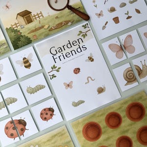 May include: A collection of children's educational materials with a garden theme. The set includes illustrated cards, puzzles, and a magnifying glass. The main title is "Garden Friends". The illustrations feature insects, flowers, and garden tools.