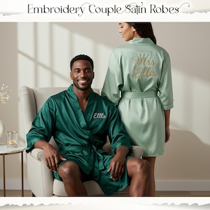 May include: Emerald green and pale green satin robes. The emerald robe has "Ellis" embroidered in white on the front. The pale green robe has "Mrs Ellis" embroidered in gold on the back. The robes are tied at the waist.