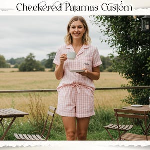 May include: Pink and white checkered pajama set with a short-sleeved top and shorts. The top has a collar and a small embroidered detail. The text "Checkered Pajamas Custom" is at the top of the image.