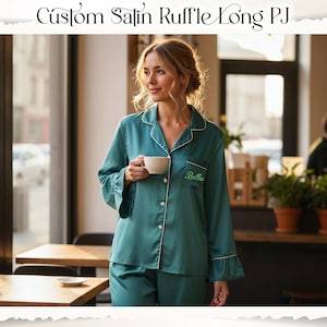May include: Teal satin pajama set with white trim and ruffle details. The long-sleeved top has a breast pocket with embroidered text. The matching pants complete the set. The text "Custom Satin Ruffle Long PJ" is at the top of the image.